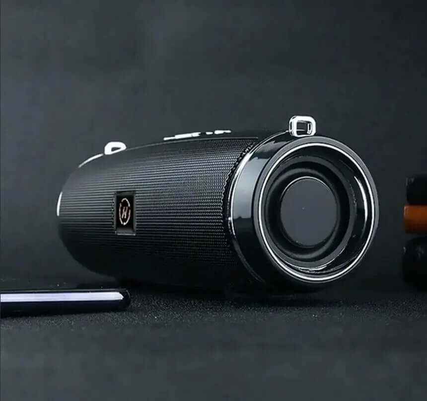 Portable waterproof Bluetooth speaker in black with cylindrical design and front-facing bass driver for outdoor camping and travel use