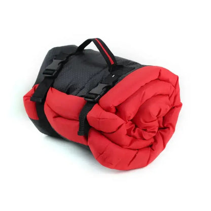 Portable dog bed for camping and travel rolled up with carrying strap