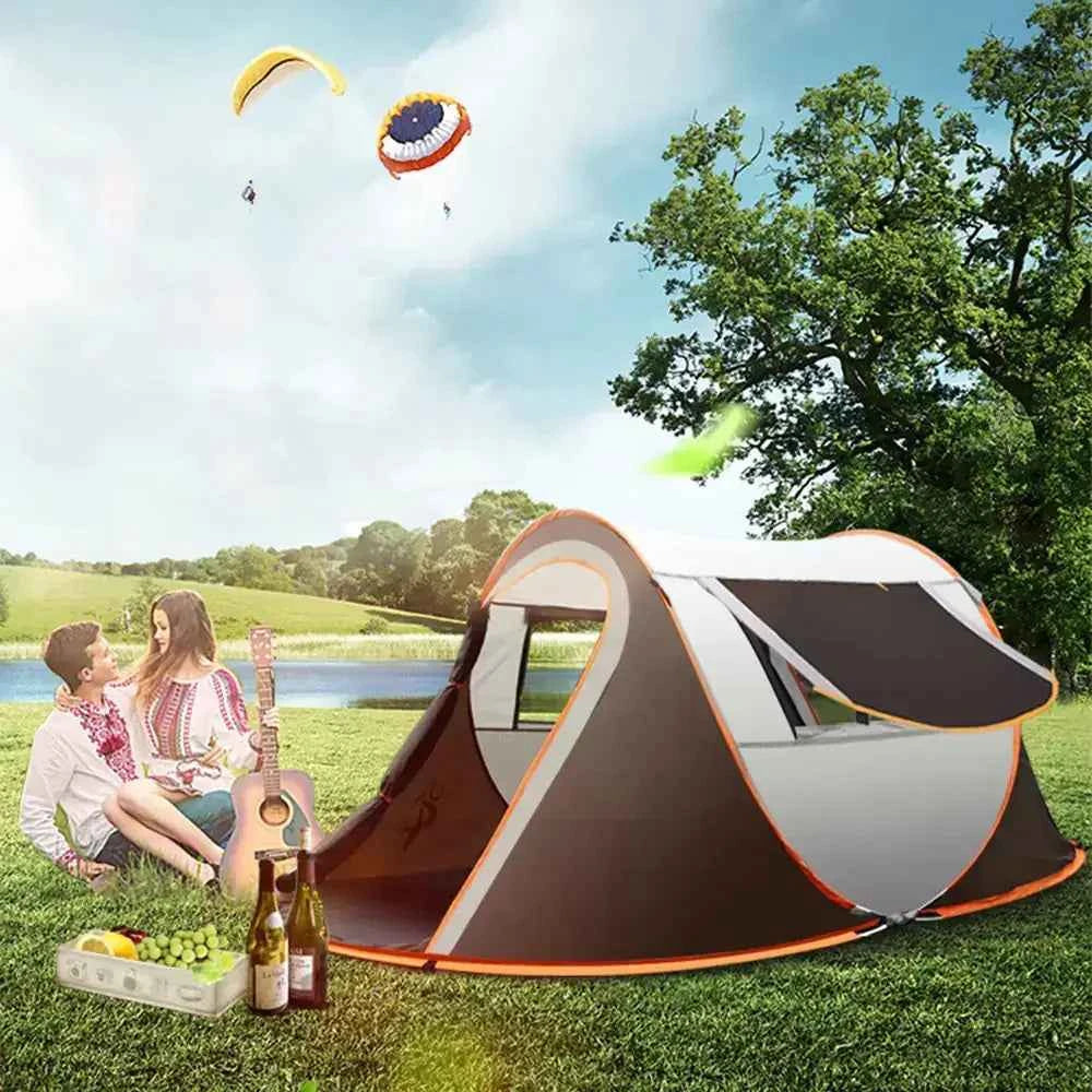 Pop-up camping tent set up outdoors with a couple relaxing on the grass, showing spacious instant setup design ideal for camping and outdoor adventures.